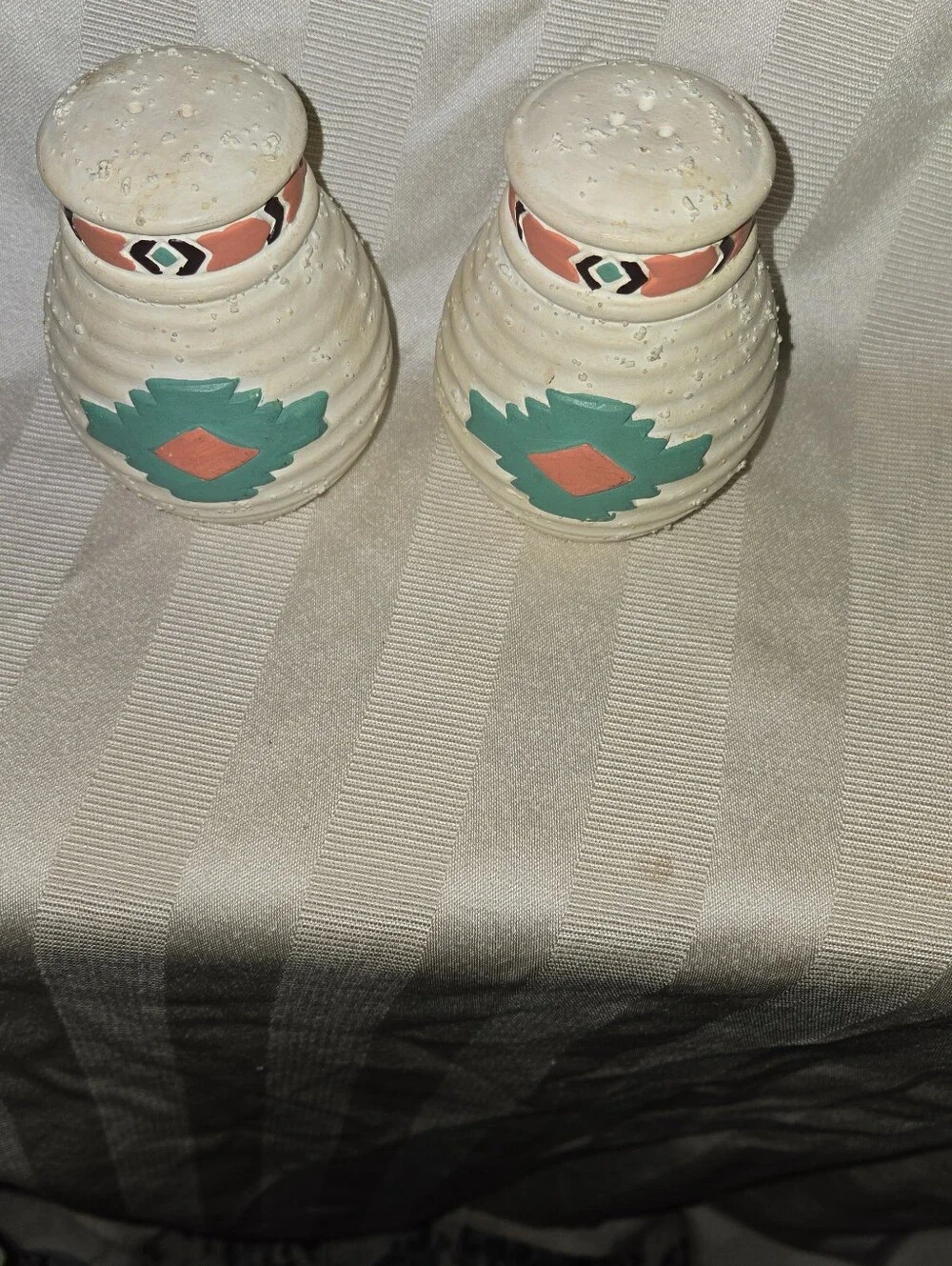 Handcrafted Southwestern Salt and Pepper Shakers with Teal and Coral Accents.